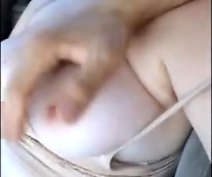 Playing with her boobs in the car
